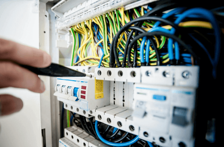 Electrician working on circuit breaker panel