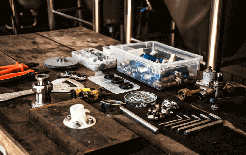 Various plumbing tools on a wooden table for sustainable business